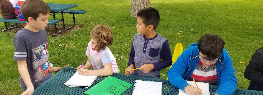 Group of students writing outside