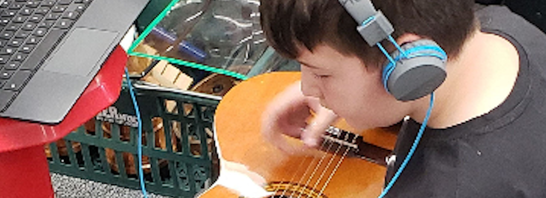 Student playing the guitar