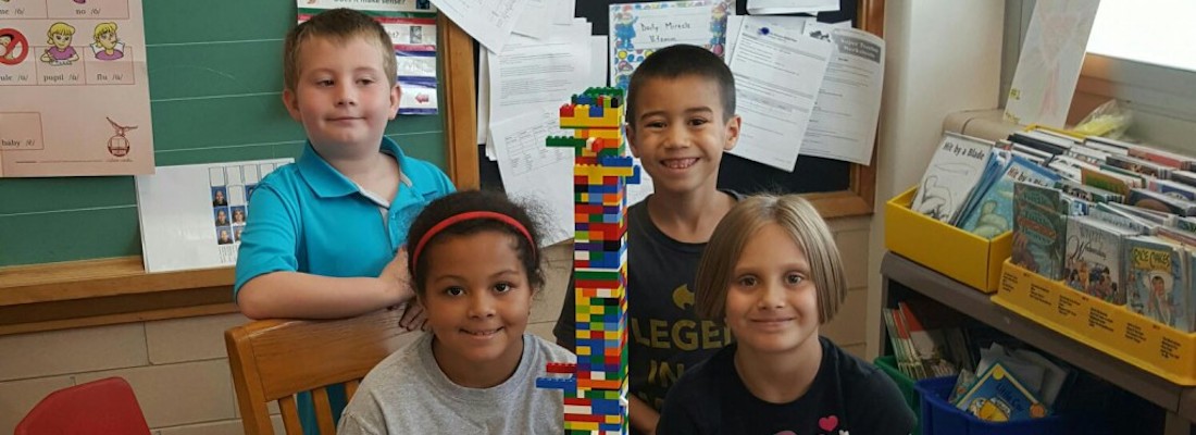 Students posing with Legos